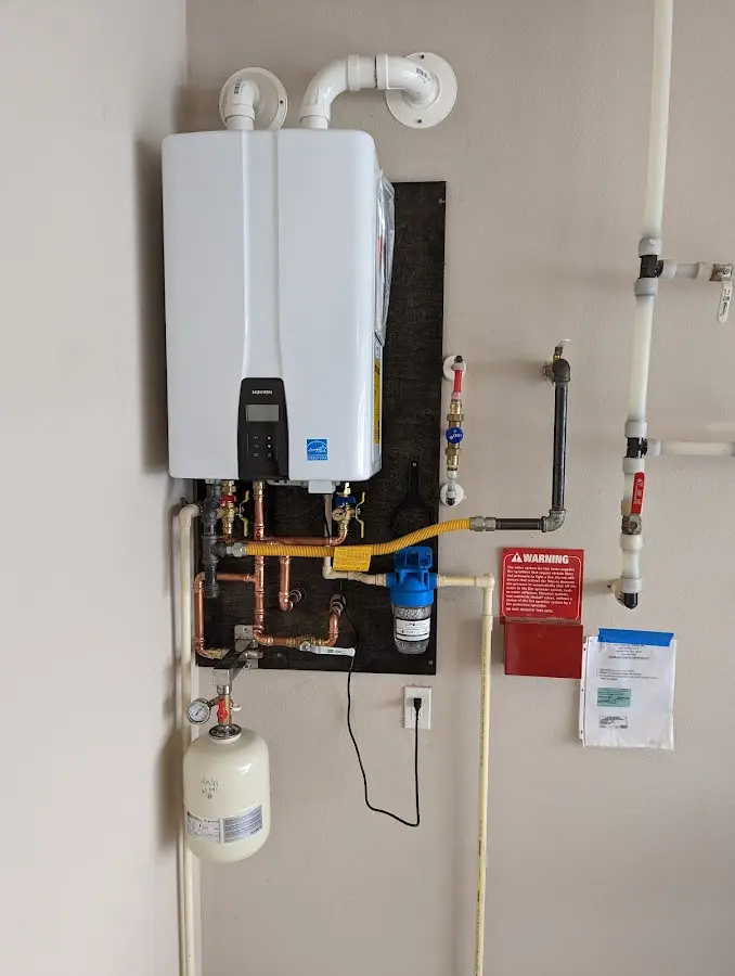 Professional plumber installing copper piping in a River Falls home
